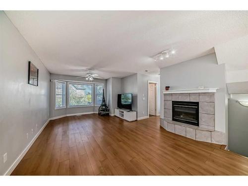 27 Sandarac Villas Nw, Calgary, AB - Indoor Photo Showing Living Room With Fireplace