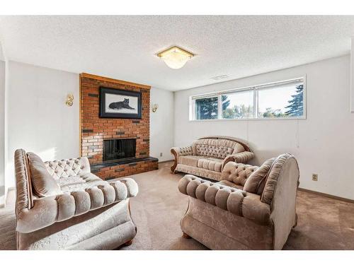 612 Hunterston Bay Nw, Calgary, AB - Indoor Photo Showing Living Room With Fireplace