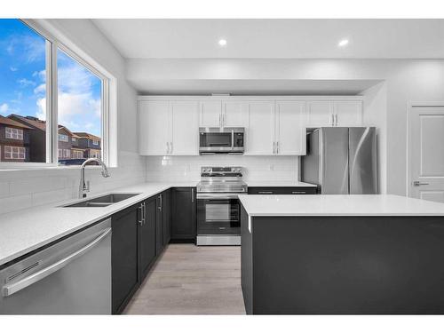 115 Aquila Drive Nw, Calgary, AB - Indoor Photo Showing Kitchen With Stainless Steel Kitchen With Double Sink With Upgraded Kitchen