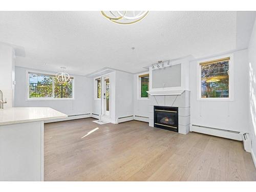 104-2419 Erlton Road Sw, Calgary, AB - Indoor Photo Showing Living Room With Fireplace