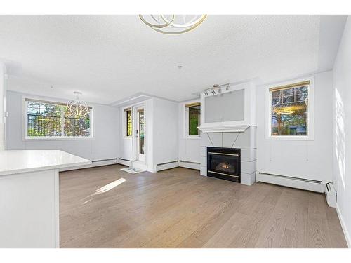 104-2419 Erlton Road Sw, Calgary, AB - Indoor Photo Showing Living Room With Fireplace