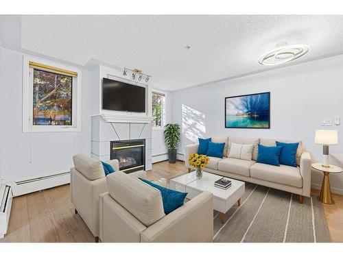 104-2419 Erlton Road Sw, Calgary, AB - Indoor Photo Showing Living Room With Fireplace