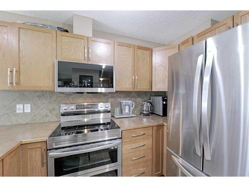 1204-800 Yankee Valley Boulevard Se, Airdrie, AB - Indoor Photo Showing Kitchen With Stainless Steel Kitchen