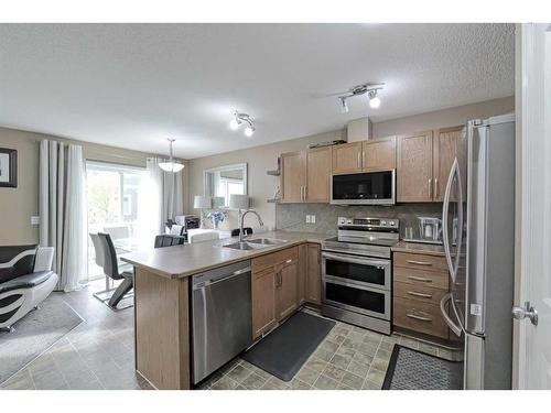 1204-800 Yankee Valley Boulevard Se, Airdrie, AB - Indoor Photo Showing Kitchen With Stainless Steel Kitchen With Double Sink