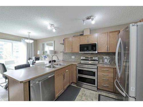 1204-800 Yankee Valley Boulevard Se, Airdrie, AB - Indoor Photo Showing Kitchen With Stainless Steel Kitchen With Double Sink