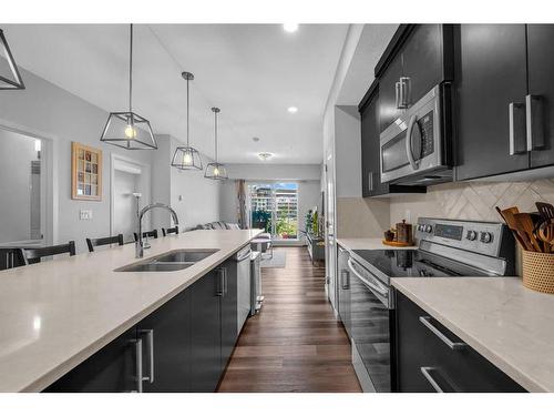 307-4150 Seton Drive Se, Calgary, AB - Indoor Photo Showing Kitchen With Double Sink With Upgraded Kitchen