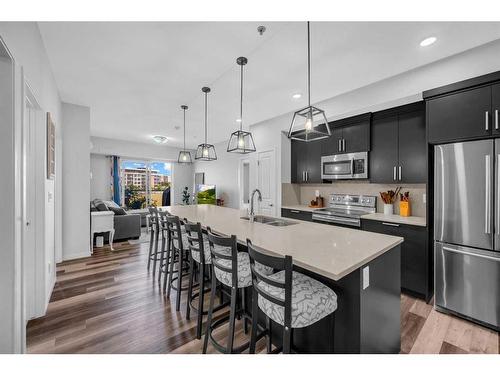 307-4150 Seton Drive Se, Calgary, AB - Indoor Photo Showing Kitchen With Stainless Steel Kitchen With Double Sink With Upgraded Kitchen