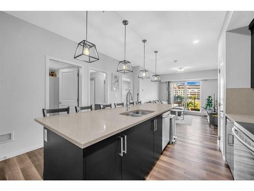 307-4150 Seton Drive Se, Calgary, AB - Indoor Photo Showing Kitchen With Double Sink With Upgraded Kitchen