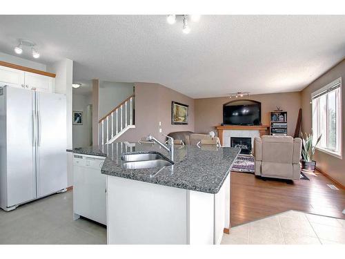 12 Panorama Hills Cove Nw, Calgary, AB - Indoor Photo Showing Kitchen With Fireplace With Double Sink