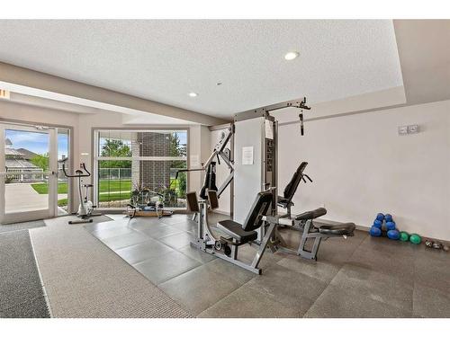 308-1 Crystal Green Lane, Okotoks, AB - Indoor Photo Showing Gym Room