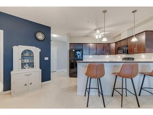 308-1 Crystal Green Lane, Okotoks, AB - Indoor Photo Showing Kitchen With Upgraded Kitchen