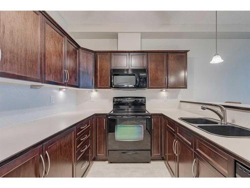 308-1 Crystal Green Lane, Okotoks, AB - Indoor Photo Showing Kitchen With Double Sink