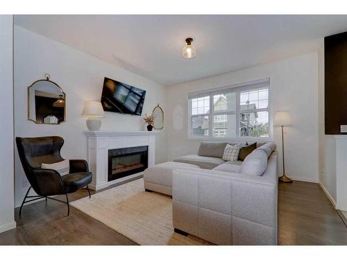 340 Kingsmere Way Se, Airdrie, AB - Indoor Photo Showing Living Room With Fireplace