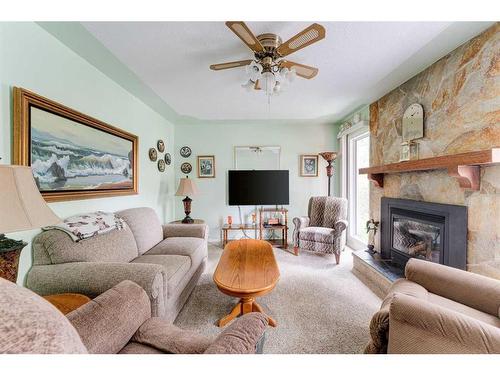 4719 69 Street Nw, Calgary, AB - Indoor Photo Showing Living Room With Fireplace