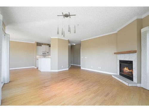 308-200 Patina Court Sw, Calgary, AB - Indoor Photo Showing Living Room With Fireplace