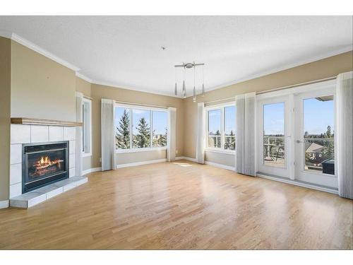 308-200 Patina Court Sw, Calgary, AB - Indoor Photo Showing Living Room With Fireplace