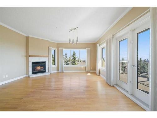 308-200 Patina Court Sw, Calgary, AB - Indoor Photo Showing Living Room With Fireplace