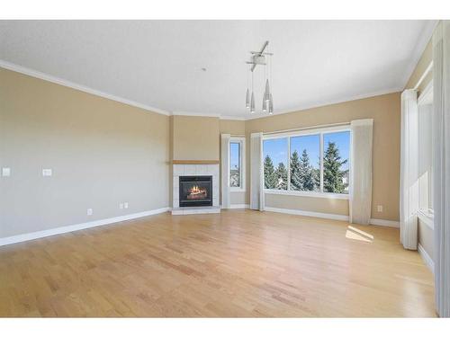 308-200 Patina Court Sw, Calgary, AB - Indoor Photo Showing Living Room With Fireplace