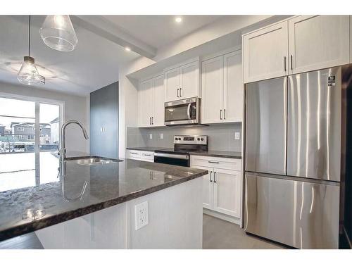 67 Lambeau Lane Se, Airdrie, AB - Indoor Photo Showing Kitchen With Stainless Steel Kitchen With Upgraded Kitchen