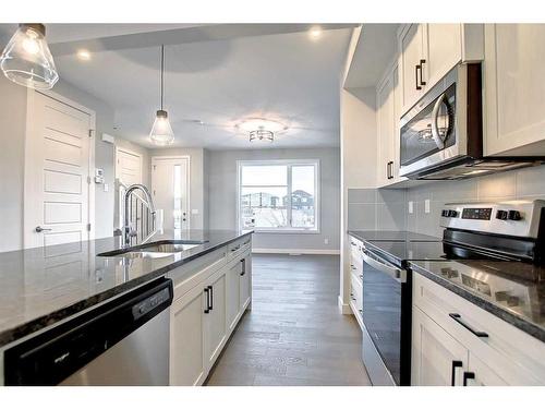 67 Lambeau Lane Se, Airdrie, AB - Indoor Photo Showing Kitchen With Double Sink With Upgraded Kitchen