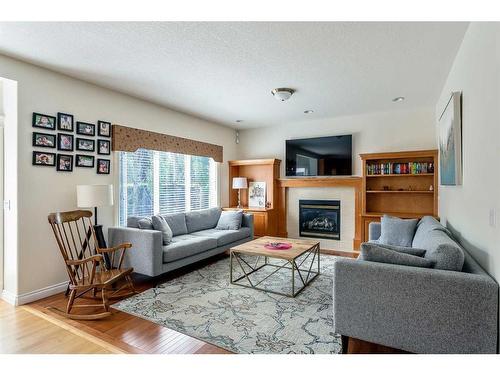 11 Evercreek Bluffs Road Sw, Calgary, AB - Indoor Photo Showing Living Room With Fireplace