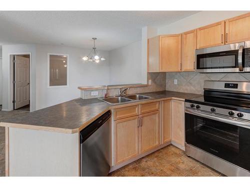 2207-950 Arbour Lake Road Nw, Calgary, AB - Indoor Photo Showing Kitchen With Stainless Steel Kitchen With Double Sink