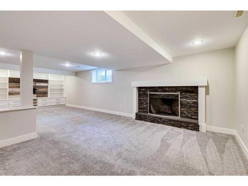 12222 Lake Erie Road Se, Calgary, AB - Indoor Photo Showing Basement With Fireplace