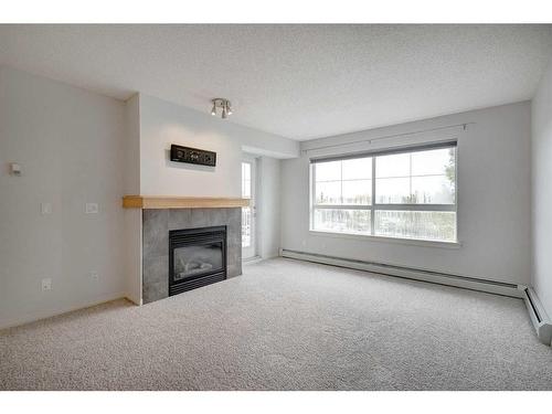 428-22 Richard Place Sw, Calgary, AB - Indoor Photo Showing Living Room With Fireplace