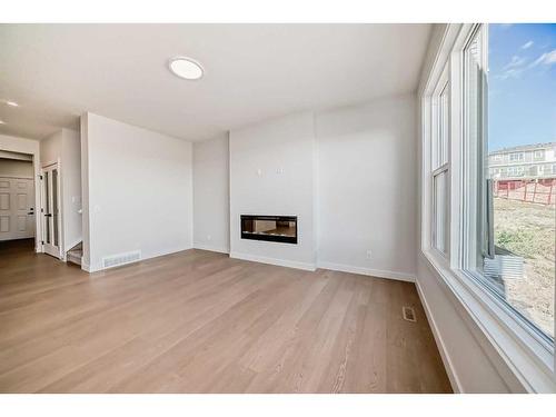 44 Carringvue Passage Nw, Calgary, AB - Indoor Photo Showing Other Room With Fireplace