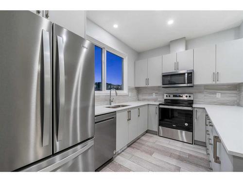 97 Corner Glen Way Ne, Calgary, AB - Indoor Photo Showing Kitchen With Stainless Steel Kitchen With Double Sink With Upgraded Kitchen