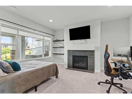 357 Bayside Crescent Sw, Airdrie, AB - Indoor Photo Showing Bedroom With Fireplace