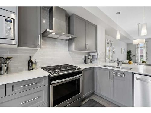 243 Legacy Common Se, Calgary, AB - Indoor Photo Showing Kitchen With Stainless Steel Kitchen With Double Sink With Upgraded Kitchen