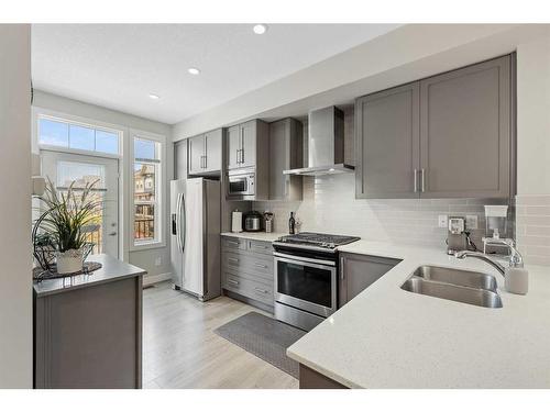 243 Legacy Common Se, Calgary, AB - Indoor Photo Showing Kitchen With Stainless Steel Kitchen With Double Sink