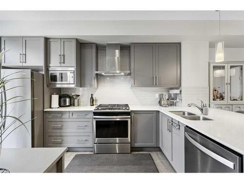 243 Legacy Common Se, Calgary, AB - Indoor Photo Showing Kitchen With Stainless Steel Kitchen With Double Sink With Upgraded Kitchen