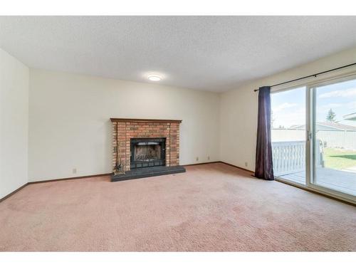 51 Sandstone Rise Nw, Calgary, AB - Indoor Photo Showing Living Room With Fireplace