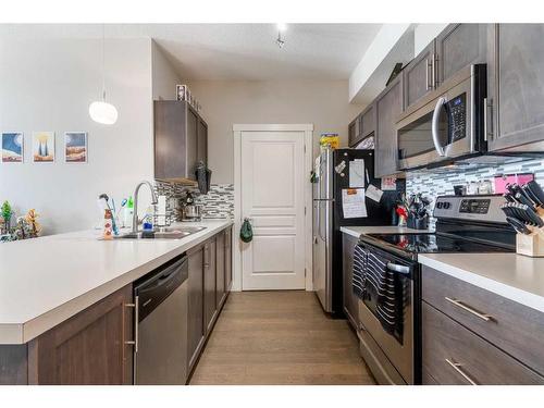 411-2300 Evanston Square Nw, Calgary, AB - Indoor Photo Showing Kitchen With Double Sink