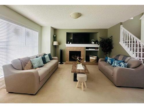 112 Silverado Plains View Sw, Calgary, AB - Indoor Photo Showing Living Room With Fireplace