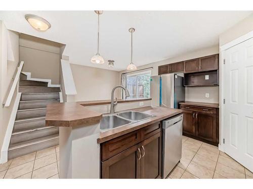 99 Panatella Park Nw, Calgary, AB - Indoor Photo Showing Kitchen With Double Sink