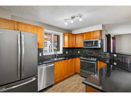 1402-8810 Royal Birch Boulevard Nw, Calgary, AB - Indoor Photo Showing Kitchen With Double Sink