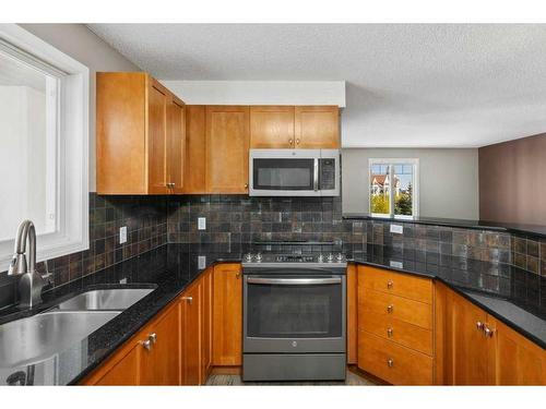 1402-8810 Royal Birch Boulevard Nw, Calgary, AB - Indoor Photo Showing Kitchen With Double Sink