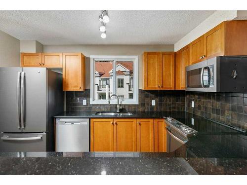 1402-8810 Royal Birch Boulevard Nw, Calgary, AB - Indoor Photo Showing Kitchen With Double Sink