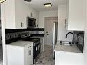 16-2020 16 Avenue Nw, Calgary, AB  - Indoor Photo Showing Kitchen With Double Sink 