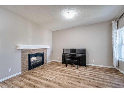 133 Panatella Parade Nw, Calgary, AB - Indoor Photo Showing Living Room With Fireplace