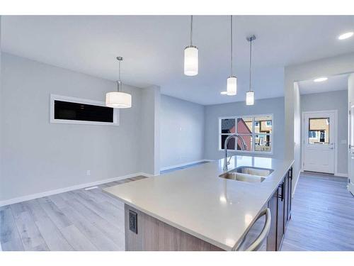 954 Cobblemore Common Sw, Airdrie, AB - Indoor Photo Showing Kitchen With Double Sink