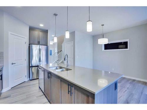 954 Cobblemore Common Sw, Airdrie, AB - Indoor Photo Showing Kitchen With Stainless Steel Kitchen With Double Sink With Upgraded Kitchen