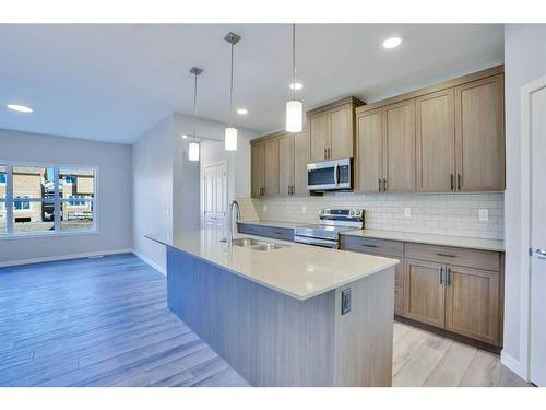 954 Cobblemore Common Sw, Airdrie, AB - Indoor Photo Showing Kitchen With Double Sink With Upgraded Kitchen