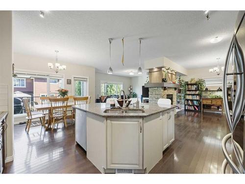 56 Jumping Pound Rise, Cochrane, AB - Indoor Photo Showing Kitchen With Double Sink With Upgraded Kitchen