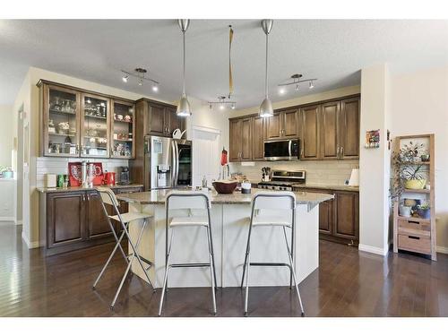 56 Jumping Pound Rise, Cochrane, AB - Indoor Photo Showing Kitchen With Upgraded Kitchen