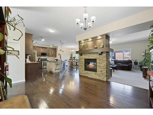 56 Jumping Pound Rise, Cochrane, AB - Indoor Photo Showing Living Room With Fireplace