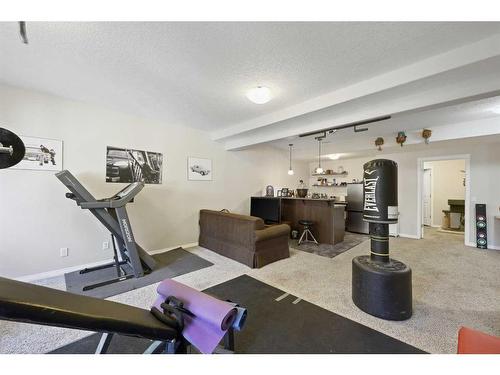 56 Jumping Pound Rise, Cochrane, AB - Indoor Photo Showing Gym Room